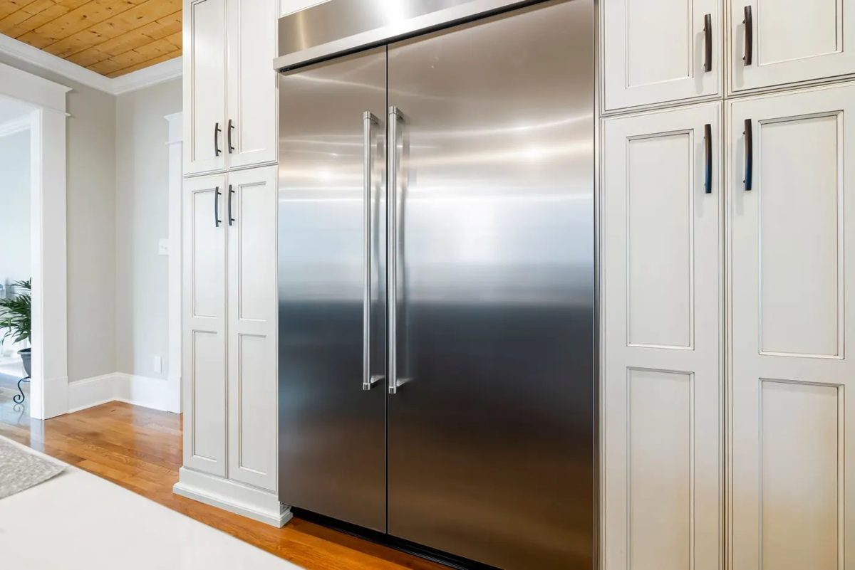 Built-in stainless refrigerator with white cabinetry